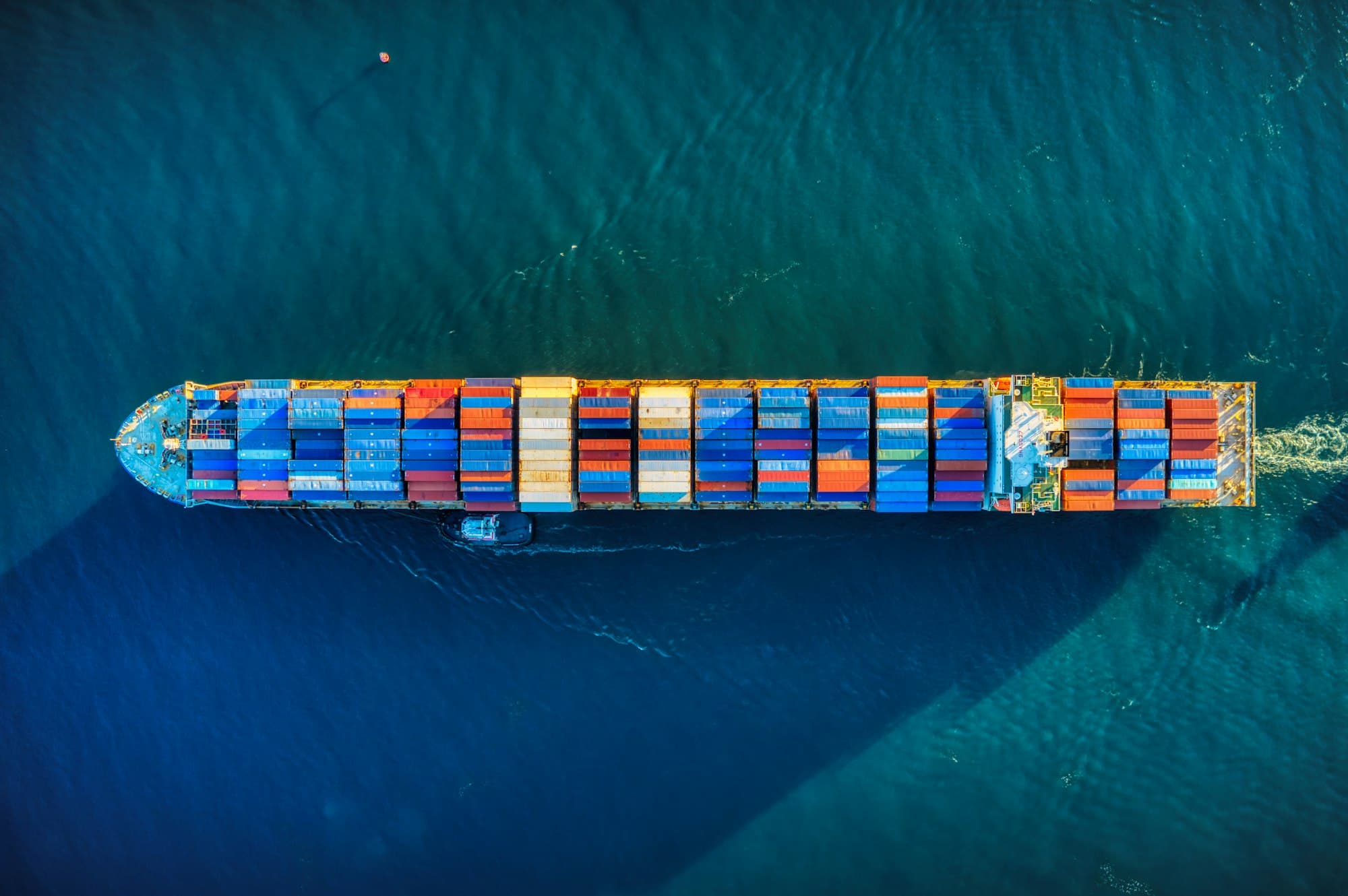Container ship crossing open water, seen from above